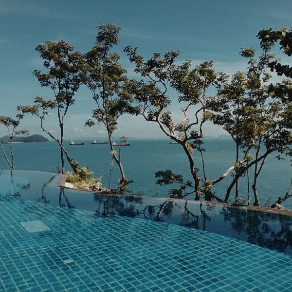 Luxury resort infinity pool overlooking Sri Lankan coastline showing premium travel experience