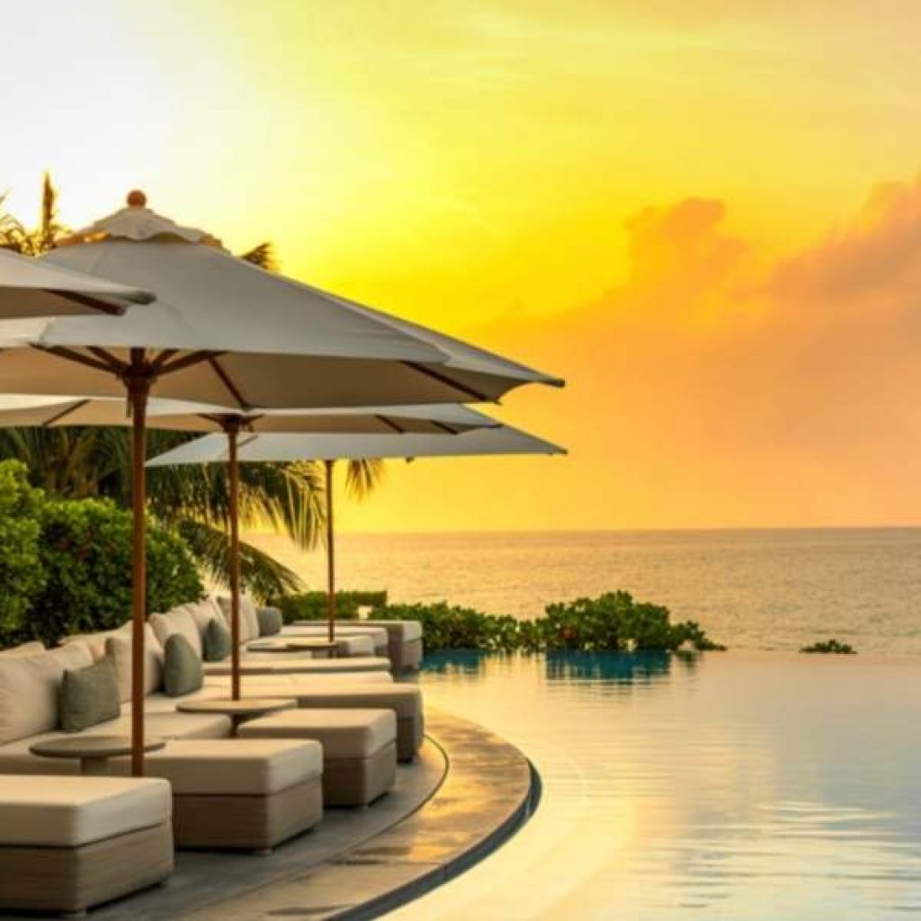 Luxury resort infinity pool overlooking Sri Lankan coastline showing premium travel experience