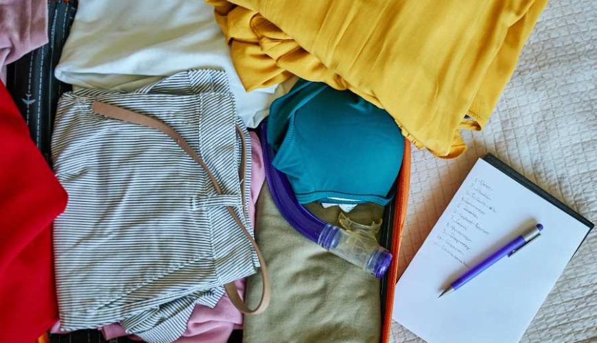 Sri Lanka packing list essentials laid out on bed including lightweight clothes and travel gear