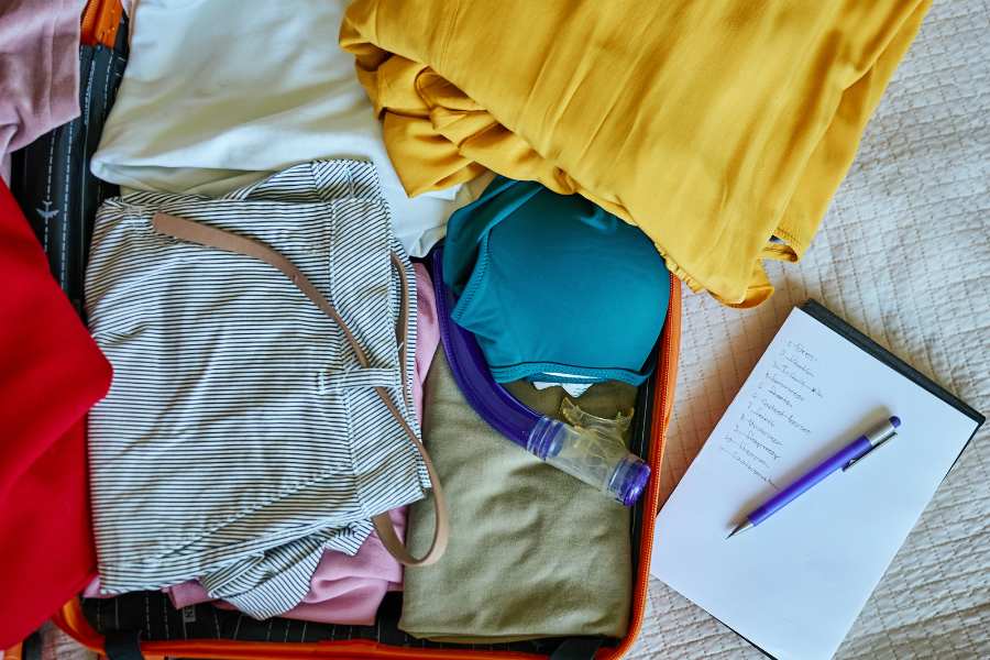Sri Lanka packing list essentials laid out on bed including lightweight clothes and travel gear